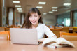 © zhu difeng - Asian beautiful female student study in library with laptop