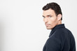 © stockyimages - Calm man looking back over his shoulder