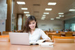 © zhu difeng - Asian beautiful female student study in library with laptop