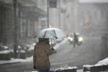 Man With Umbrella During Snow Storm