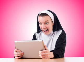 Wall Mural - Nun working on laptop - religious concept