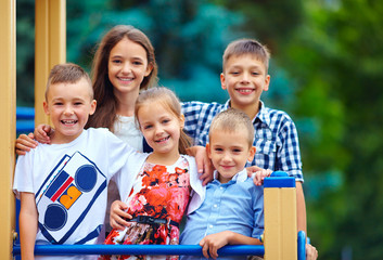 Wall Mural - group of happy kids having fun on playground