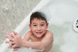 © sianc - young boy in a bath full of bubbles