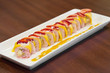 Special Dessert Sushi Roll Made with Fruit on Wooden Table