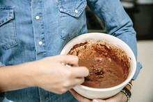 Woman Holding Bowl And Mixing Chocolate Cake Batter