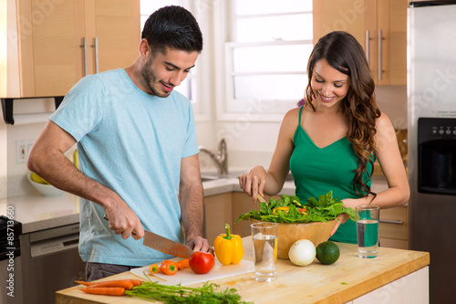 Fotografie, Obraz Attractive man and woman prepping low calorie dinner in kitchen very health cons