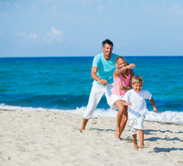 Poster - Kids and father playing on the beach.