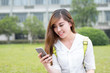 © zhu difeng - Asian beautiful female studen using mobile phone in campus