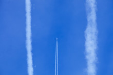 Fishing Rod Against The Blue Sky, Vapor Trail From An Airplane