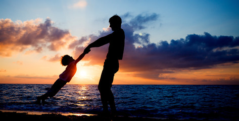 Poster - Silhouettes at sunset beach