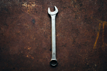 The  wrench lies on a rusty old metal background