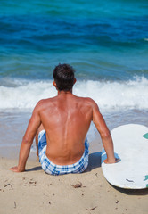 Wall Mural - Man with his surfboard on the beach