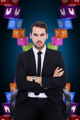 Poster - Composite image of serious businessman sitting with arms crossed