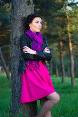 Wall Mural - beautiful woman standing near the tree in summer forest