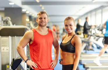 smiling man and woman in gym