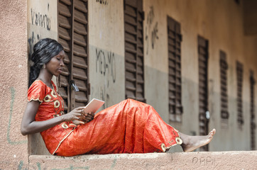 beautiful african model reading article on tablet computer pc