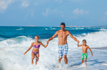 Poster - Father and children playing on the beach