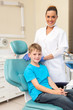 © michaeljung - little boy sitting on dentist chair