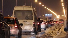 Many Cars Moves On Bridge At Winter Night During Snowfall
