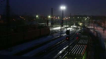 Wall Mural - Long freight trains move on railway at winter night
