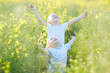 © photoniko - two boys standing in a canola field