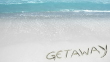 Summer Beach Getaway - Word Getaway Written On The Sand And Waves Splashing The Beach, Crystal Clear Water.. Waves Do Not Wash Off The Text.