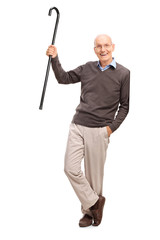 Poster - Senior gentleman showing his cane and leaning on a wall