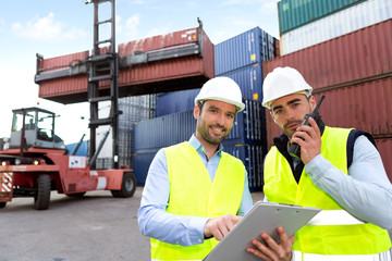 Wall Mural - Dock worker and supervisor checking containers data