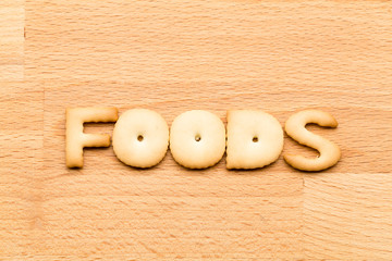 Wall Mural - Word foods biscuit over the wooden background