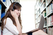 © zhu difeng - Asian beautiful female student studying in library with laptop