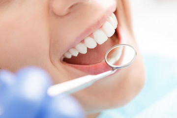 Wall Mural - Close-up of woman having her teeth examined 