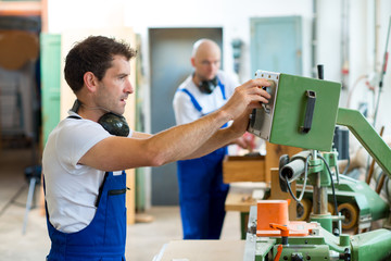 two worker in a carpenter's workshop