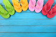Flip flops or flipflop in a row line semi circle top border with old blue wood deck decking summer beach vacation holiday family team teamwok photo