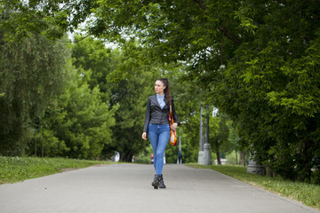 Young beautiful girl in blue jeans and a blue shirt on the backg