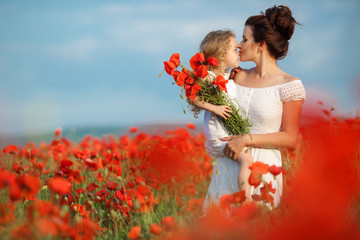 beautiful mother and little daughter in a field in summer