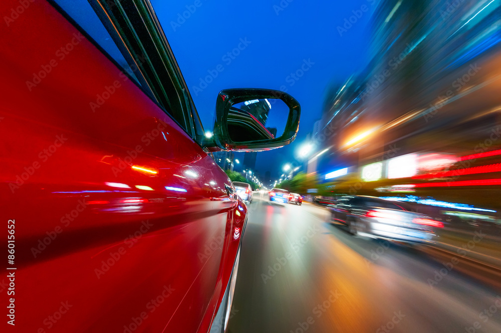 A car driving on a motorway at high speeds, overtaking other cars
