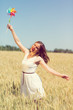 © Tinatin - Happy girl with a colorful windmill