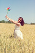 © Tinatin - Happy girl with a colorful windmill