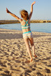 Little girl jumping on the beach