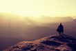 © rdonar - Hiker sits on a rocky peak and enjoy the mountains scenery