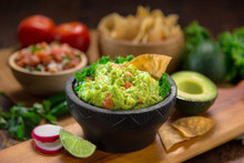 Premium Handmade Guacamole From Fresh Organic Avocados With Chips On A Table With Pico De Gallo Salsa