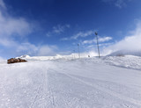 Fototapeta Natura - Ski slope and hotel in winter mountains