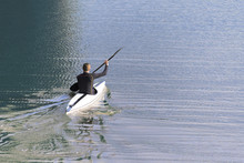 Paddler In A Kayak Alone On The Blue Water, Copy Space