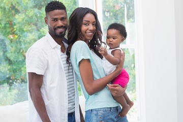 Wall Mural - Happy parents with baby girl