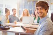 © WavebreakmediaMicro - Portrait of smiling young businessman with colleagues