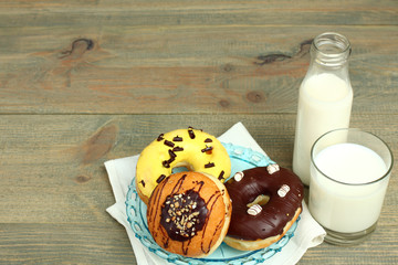 Wall Mural - Donuts and glass of milk on wooden background