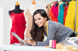 © Odua Images - Young asian designer woman using a tablet pc, smiling rested on