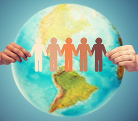 close up of human hands with earth globe