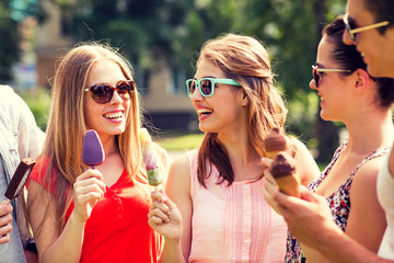 Wall Mural - group of smiling friends with ice cream outdoors