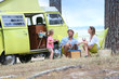 © goodluz - happy family relaxing by camper van in summer